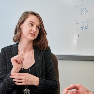 woman speaking sign language in a classroom